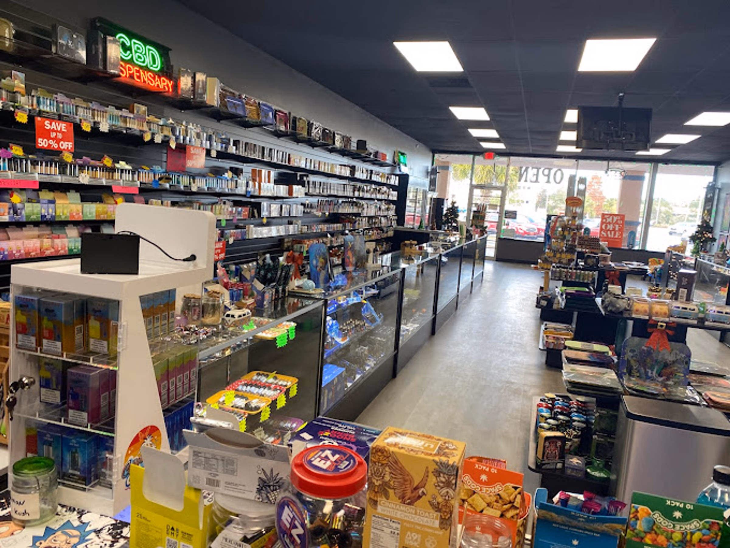 Vape and e-liquid wall under the CBD dispensary sign at Metro Smoke Shop, Mount Dora
